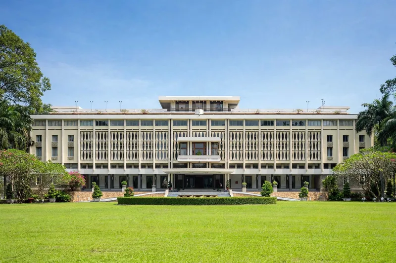 The Independence Palace facade in Saigon with its distinctive concrete lattice screens and manicured front lawn