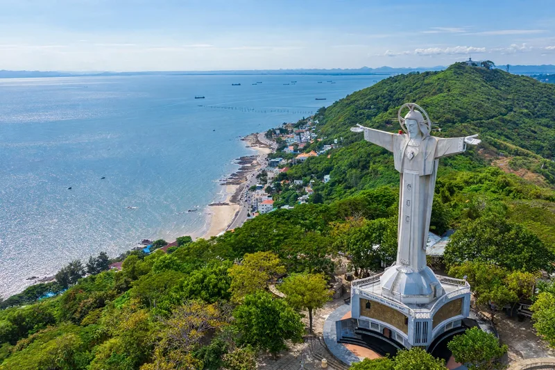 The Christ the King statue with outstretched arms on Small Mountain in Vung Tau overlooking the sea and city